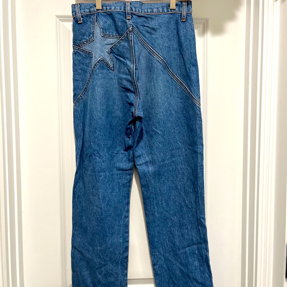 The Reformation ankle length denim jean with star design on back.